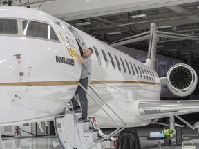 Francis Masse shine up Bombardier's new jetliner, the Global 7500, the longest-range business jet in the world at the company's finishing plant in Montreal, Wednesday, Dec. 19, 2018.