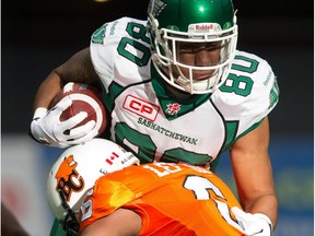 Saskatchewan Roughriders' Spencer Moore is tackled by B.C. Lions' T.J. Lee after making a reception during the first half in Vancouver on Oct. 3, 2015.