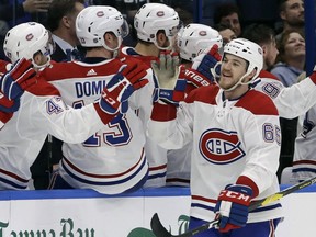 Montreal Canadiens right wing Andrew Shaw (65) celebrates with the bench after his goal against the Tampa Bay Lightning during the second period of an NHL hockey game Saturday, Dec. 29, 2018, in Tampa, Fla.