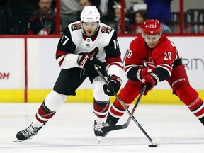 Coyotes' Alex Galchenyuk, left, keeps the puck away from Hurricanes' Sebastian Aho (20) during game this month in Raleigh, N.C.