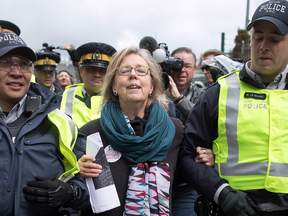 Federal Green Party Leader Elizabeth May is arrested by RCMP officers after joining protesters outside Kinder Morgan's facility in Burnaby, B.C., on March 23, 2018.