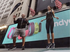 Fitness expert Harley Pasternak and actress Jordana Brewster lead a workout, on behalf of Fitbit, in front of the New York Stock Exchange in 2015. Wearable technology ranks No. 1 on the list of 2019 fitness trends.