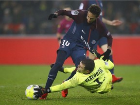 Caen goalkeeper Rémy Vercoutre stops Paris Saint Germain's Neymar during the French Ligue 1 match in Paris on Dec. 20, 2017.