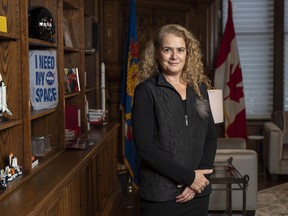 Governor General Julie Payette stands next to a shelf featuring memorabilia from her career as an astronaut, in her office at Rideau Hall in Ottawa on Tuesday, Dec. 11, 2018.