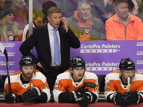 In this Nov. 27, 2018, file photo, Flyers head coach Dave Hakstol watches from the bench during an NHL game against the Senators, in Philadelphia.
