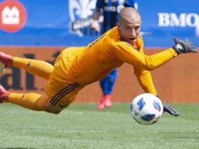 Montreal Impact goalkeeper Evan Bush makes a save against the New England Revolution during first half on May 5, 2018, in Montreal.