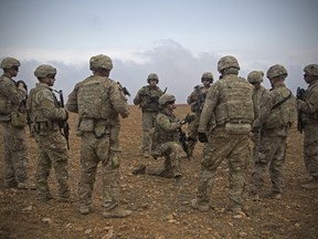In this Nov. 7, 2018, photo released by the U.S. Army, U.S. soldiers gather for a brief during a combined joint patrol rehearsal in Manbij, Syria. The United States main ally in Syria on Thursday, Dec. 20, 2018, rejected President Donald Trumps claim that Islamic State militants have been defeated and warned that the withdrawal of American troops would lead to a resurgence of the extremist group.