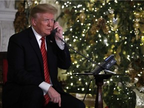 President Donald Trump speaks on the phone sharing updates to track Santa's movements from the North American Aerospace Defense Command (NORAD) Santa Tracker on Christmas Eve, Monday, Dec. 24, 2018.