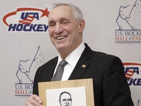 Retired NHL hockey referee Paul Stewart poses with his plaque before being inducted into the U.S. Hockey Hall of Fame, Wednesday, Dec. 12, 2018, in Nashville, Tenn.