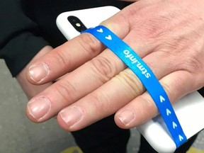 The city's transit agency is distributing free cellphone straps in hopes fewer people will drop theirs on the tracks. (Photo courtesy STM)