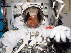 Former Canadian astronaut Dave Williams in his spacesuit getting ready for a spacewalk in a NASA handout photo.