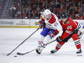 Montreal Canadiens center Michael Chaput (43) battles for the puck with Chicago Blackhawks left wing Brandon Saad (20) during the first period of an NHL hockey game Sunday, Dec. 9, 2018, in Chicago.