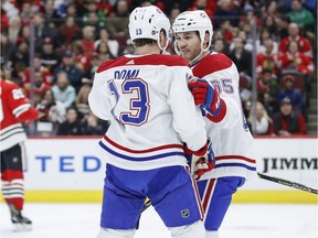 Montreal Canadiens left wing Max Domi (13) celebrates with right wing Andrew Shaw (65) after scoring against the Chicago Blackhawks during the first period of an NHL hockey game Sunday, Dec. 9, 2018, in Chicago.