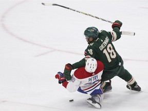 Minnesota Wild's Jordan Greenway and Montreal Canadiens' Jeff Petry fall over each other after trying to get the puck in the third period of an NHL hockey game, Tuesday, Dec. 11, 2018, in St. Paul, Minn. The Wild won 7-1.