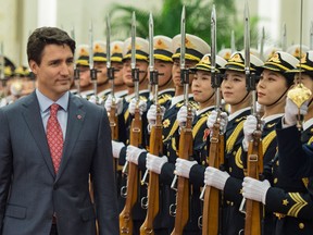 Canada's Prime Minister Justin Trudeau walks during a review of Chinese paramilitary guards during a visit to in 2017.