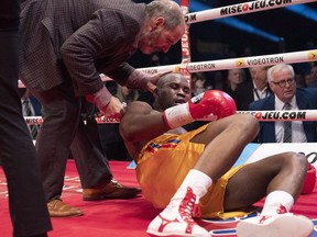 Ring doctor Marc Gagne checks on Adonis Stevenson, of Montreal, after he was knocked out by Oleksandr Gvozdyk of Ukraine in their Light Heavyweight WBC championship fight, Saturday, Dec. 1, 2018 in Quebec City.