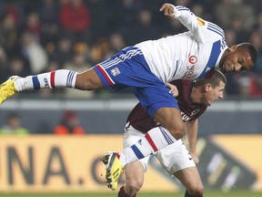 Olympique Lyon's Harry Novillo dives over Manuel Pamic from Sparta Prague during Europa League, Group I match in Prague, Czech Republic on Nov. 22, 2012.