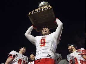 Laval University Rouge et Or's Mathieu Betts raises the trophy as they celebrate defeating Western University Mustang at the Vanier Cup final Saturday, November 24, 2018 in Quebec City. Laval Rouge et Or defensive end Mathieu Betts is the top-ranked player in the CFL Scouting Bureau's December rankings for the 2019 Canadian draft.