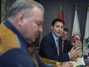 Prime Minister Justin Trudeau meets with David Chartrand, left, president of the Manitoba Metis Federation and member of the Board of Governors of the Metis National Council, and other Indigenous leaders at the first ministers' meeting in Montreal on Friday, December 7, 2018. To the right is Intergovernmental Minister Dominic LeBlanc.