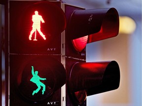 Walking figures depicting late US rock and roll legend Elvis Presley appear on a traffic light switching from green to red in Friedberg near Frankfurt, Germany, Thursday, Dec. 6, 2018. Presley served in Friedberg from October 1958 to March 1960 as a soldier in the US Armed Forces.( AP Photo/Michael Probst) ORG XMIT: PFRI101