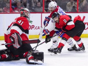 Canadiens' Kenny Agostino battles Senators' Dylan DeMelo for the puck in front of goalie Craig Anderson Thursday night in Ottawa.