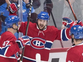 Canadiens' Tomas Tatar (90) celebrates with teammates Kenny Agostino (47) and David Schlemko after scoring against the New York Rangers in Montreal on Saturday, Dec. 1, 2018.