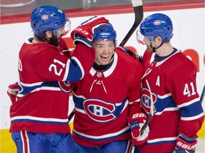 The Canadiens' Max Domi (centre) celebrates with teammates David Schlemko (21) and Paul Byron (41) after scoring goal against the Ottawa Senators during the second period of NHL game at the Bell Centre in Montreal on Dec. 4, 2018.
