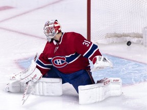 The puck goes into the net past Canadiens goaltender Carey Price on a goal by San Jose Sharks' Justin Braun in Montreal on Sunday, Dec. 2, 2018.
