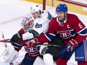 San Jose Sharks' Marcus Sorensen is sandwiched between Canadiens goaltender Carey Price and defenceman Shea Weber in Montreal on Sunday, Dec. 2, 2018.