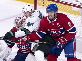 San Jose Sharks' Marcus Sorensen is sandwiched between Montreal Canadiens goaltender Carey Price and defenceman Shea Weber during first period in Montreal on Dec. 2, 2018.