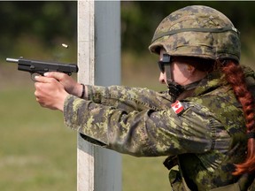 Master Cpl. Tatyana Danylyshyn, 25, fires a 9mm Browning pistol in Wainwright, Alta. in 2010.