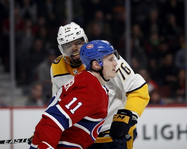 Nashville Predators defenceman P.K. Subban has words with Montreal Canadiens right wing Brendan Gallagher after being driven into the boards by Gallagher during NHL action in Montreal. I wasn't on the schedule to shoot hockey that night, but really wanted to be there for the return of P.K. Shooting through a small hole in the glass, where only a portion of the rink is viewable, I was lucky that this transpired right in front of my window to the rink.