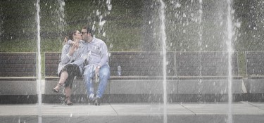 I was walking around downtown looking for pictures between two assignments — Place des Festivals always brings out people. I saw Mikael Gervais and Laurence Crete on the other side of the fountain, enjoying a romantic weekend away from their hometown, Gatineau. I took pictures of them talking, looking at maps, drinking water — and then they kissed.