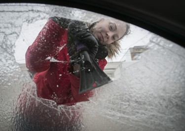 Freezing rain hit the city overnight and we needed something early for the web. Marie-Philippe Bois was already well underway de-icing her vehicle and she was gracious enough to let me get inside her car to get this picture.