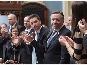 Premier François Legault is applauded by his caucus during the inaugural speech, Wednesday, November 28, 2018 at the legislature in Quebec City. In the speech, he said he would protect the historical rights of English-speaking Quebecers, a promise at odds with his plan to abolish the community's school boards along with others across the province, Dan Lamoureux says.