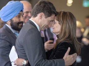 Prime Minister Justin Trudeau shares a moment with Hélène Desmarais, chief executive of the Centre d’entreprises et d’innovation de Montréal (CEIM), as Minister of Innovation, Science and Economic Development Navdeep Bains looks on after her speech at the Element AI conference in Montreal on Dec. 6.