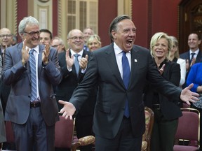 Quebec Premier designate Francois Legault reacts to the applauding crowd as he arrives to be sworn in as member of the National Assembly Tuesday, October 16, 2018 at the legislature in Quebec City.