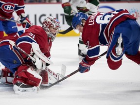 Canadiens left wing Artturi Lehkonen crashes to the ice in from too Montreal Canadiens goaltender Carey Price after being hit from behind during NHL action against the Minnesota Wild in Montreal on Monday January 7, 2019.