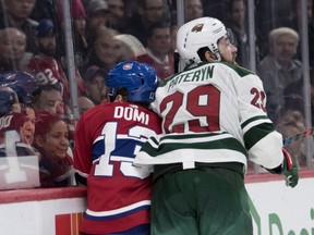 Canadiens centre Max Domi takes a hit from Wild defenceman Greg Pateryn this week. Montreal GM Marc Bergevin says one of the reasons his team's power play has been so poor is that his players are being outworked.