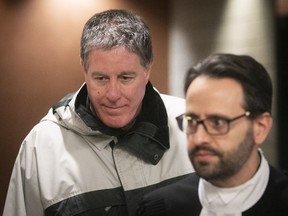 Father Brian Boucher, left, arrives at the Montreal courthouse Tuesday with defence lawyer James Cocciardi.