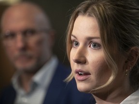 Charlotte Bouchard, sister of tennis star Eugenie Bouchard, addresses reporters at the Montreal courthouse Thursday as her father, Michel Bouchard, looks on.