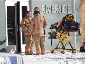 Montreal firefighters wait outside Riverside Pool, where children who were evacuated from Ecole des Decouvreurs wait Jan. 14, 2019.