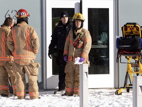 Montreal police and firefighters wait outside Riverside Pool, where children who were evacuated from Ecole des Decouvreurs wait Jan. 14, 2019.