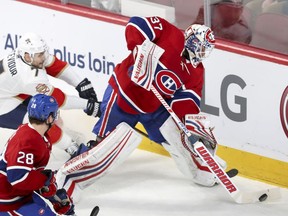 Canadiens goalie Antti Niemi comes out of his net to play loose puck with pressure from Panthers' Colton Sceviour during first period Tuesday night ta the Bell Centre. Mike Reilly was ther eto help out the Habs' netminder.