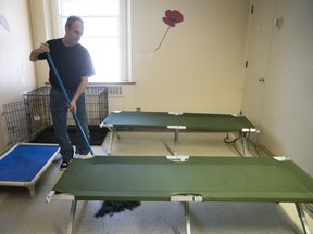 Stéphane Houle cleans up one of the new rooms available for the homeless at the old Royal Victoria Hospital on Thursday, Jan. 17.