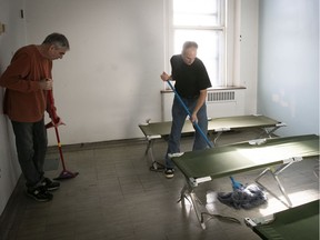 Richard Dominique, left, and Stephane Houle clean up one of the rooms available for the homeless at the old Royal Victoria Hospital site on Thursday January 17, 2019.
