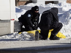 Montreal police investigate the scene where an elderly woman died after being struck by a garbage truck in Montreal on Tuesday January 22, 2019.