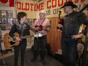 Bobby Dove, left, speaks with Bill Bland, centre, and  Dave Deeprose at the Wheel Club in N.D.G. on Monday January 21, 2019. Hillbilly Night "has allowed me to really grow as a musician by playing with some great pros," Dove says.