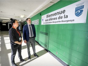 Riverdale High School principal Mat Canavan speaks with Marie Émond, responsible for the Riverdale and Lyndsay Place High School campuses of the Marguerite-Bourgeoys school board, by a welcoming poster in Riverdale in Pierrefonds on Tuesday Jan. 22, 2019.