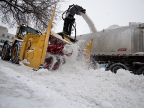 A blower clears the first of two passes needed to clear a street during snow removal operations in Montreal on Wednesday January 23, 2019.